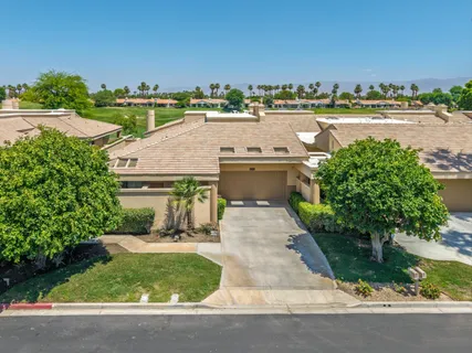 an aerial view of a house with a yard and lake view