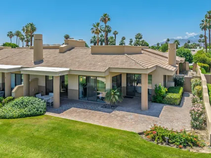 a front view of a house with garden and porch