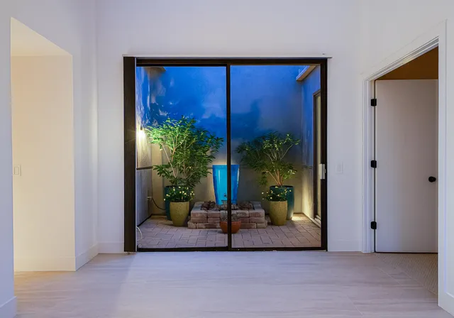 a view of a room with a large window and front door