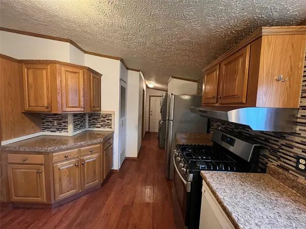 a kitchen with a stove a sink and a refrigerator