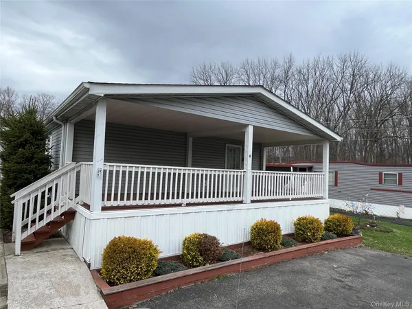 a view of a house with a small yard and a large window