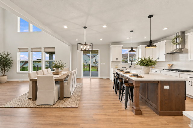 754 West 400 North Mapleton, UT 84664 - Photo 22 of 86 Virtually Staged for Decor Ideas. Open-concept living space with wood-finish flooring, a vaulted ceiling, and recessed lighting