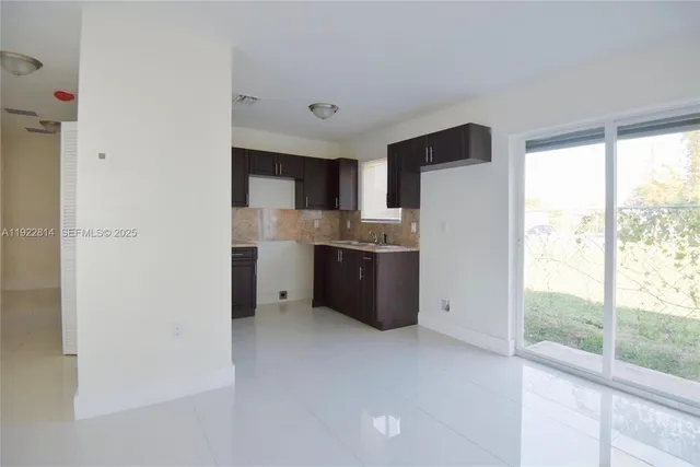 a kitchen with stainless steel appliances a refrigerator sink and cabinets