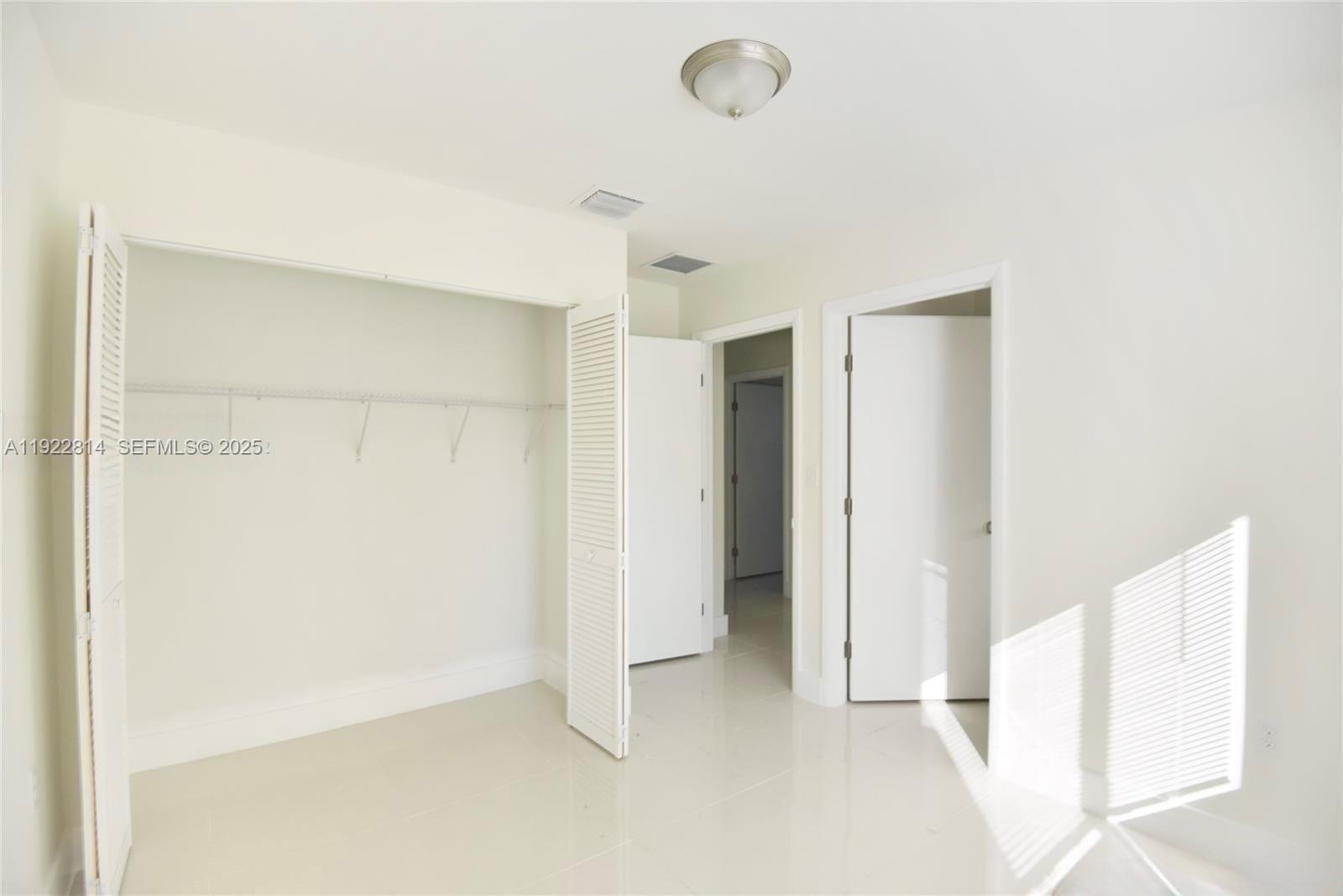 1980 Northwest 54th Street, Unit A Miami, FL 33142 - Photo 5 of 9 a view of an empty room