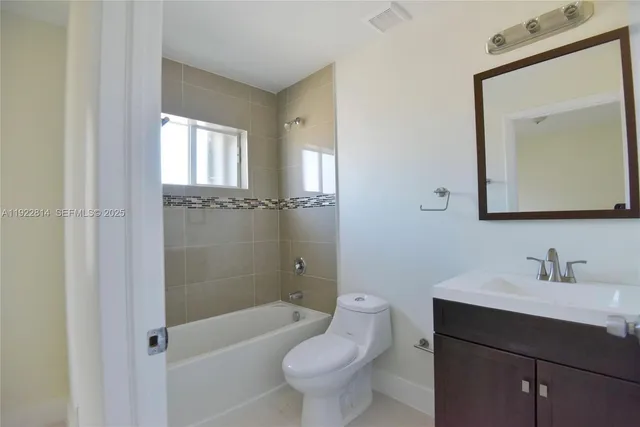 a bathroom with a toilet a sink and bathtub