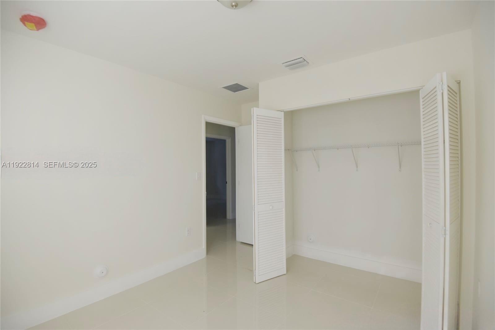 1980 Northwest 54th Street, Unit A Miami, FL 33142 - Photo 8 of 9 a view of an empty room