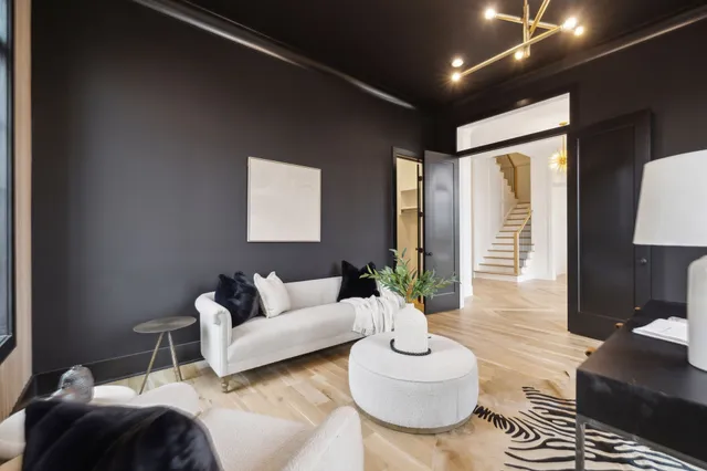 a living room with furniture a fireplace and a chandelier