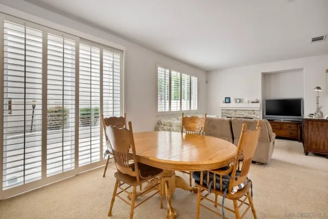 a view of a dining room with furniture and windows