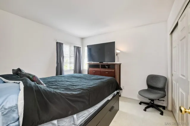 a bedroom with a bed and dresser