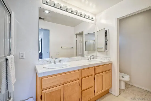 a bathroom with a granite countertop sink shower bathtub and a mirror