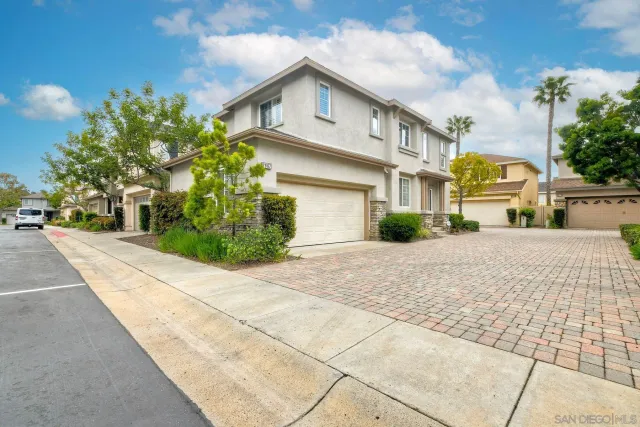 a view of multiple houses with a street