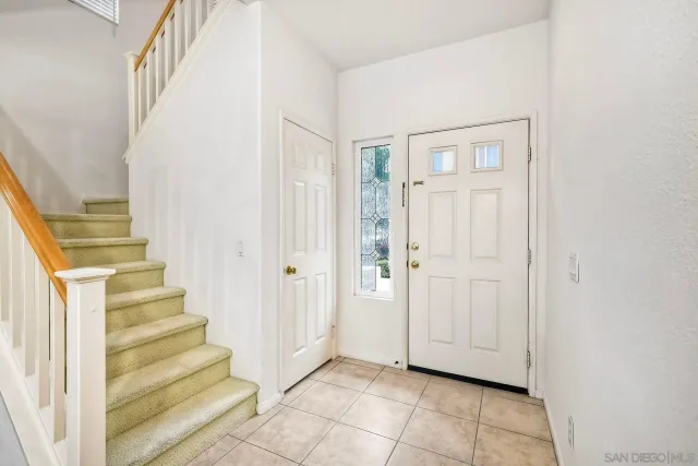 a view of entryway with wooden floor and stairs
