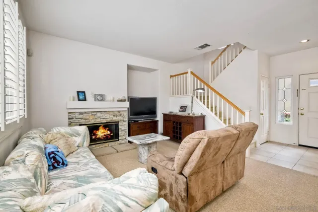 a living room with furniture fireplace and a couch