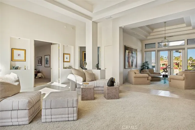 a bedroom with furniture and a large window