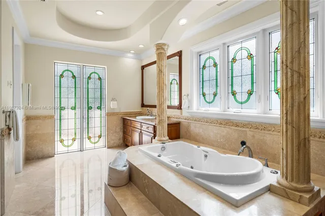 a large bathroom with a tub sink shower and mirror