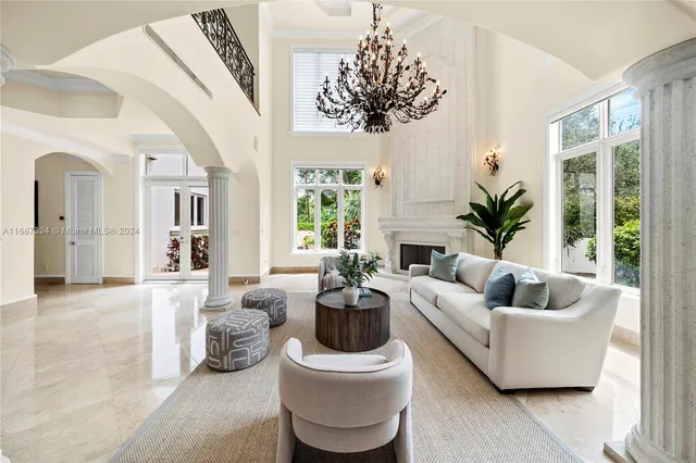 a living room with furniture and a chandelier