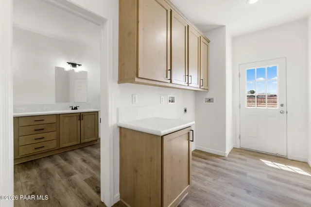 a kitchen with cabinets appliances and a wooden floor