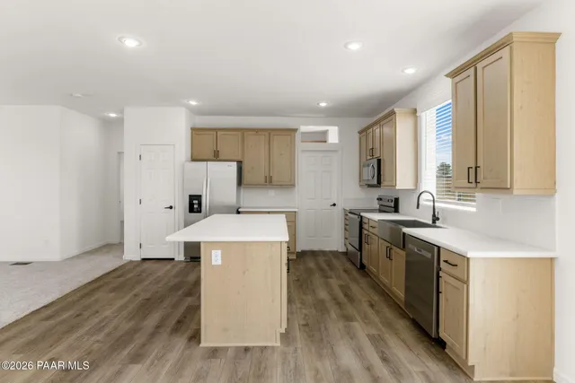 a kitchen with a stove a sink and a refrigerator