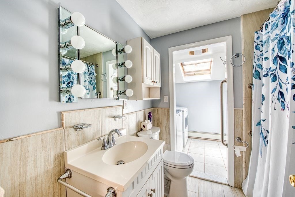 81 Errol Road Brockton, MA 02302 - Photo 15 of 31 a bathroom with a sink a toilet and a mirror