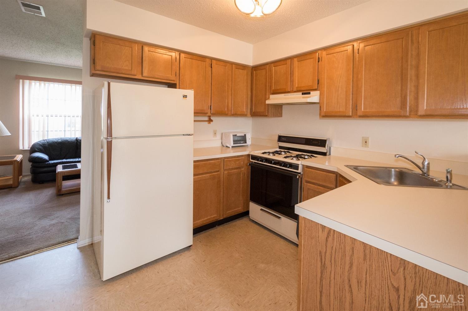 302 Pegasus Road Piscataway, NJ 08854 - Photo 2 of 27 a kitchen with a sink a stove and refrigerator