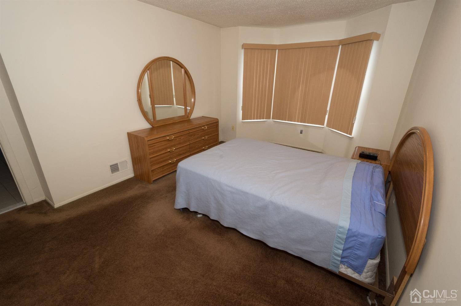 302 Pegasus Road Piscataway, NJ 08854 - Photo 17 of 27 a bedroom with a bed and a dresser
