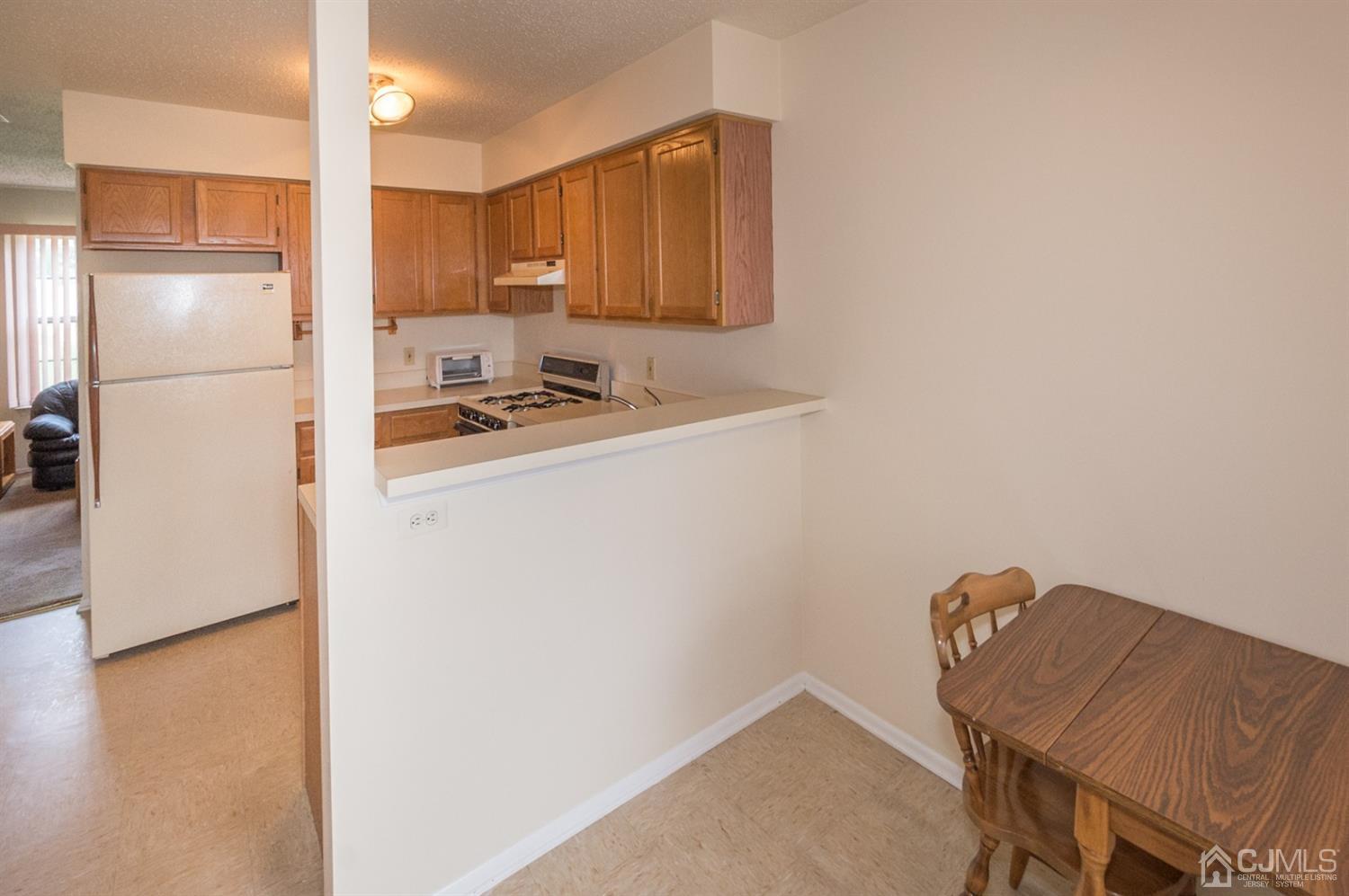 302 Pegasus Road Piscataway, NJ 08854 - Photo 4 of 27 a kitchen with a refrigerator and a stove