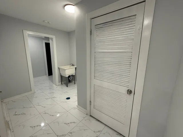 an empty room with a window and ceiling fan