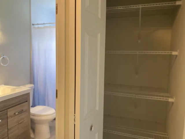 a bathroom with a toilet and a shower