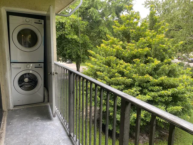 a view of a hallway with washer and dryer