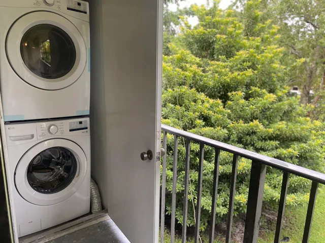 a view of a hallway with washer and dryer