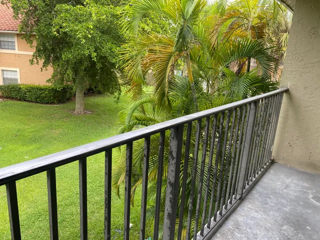 a balcony with trees in front of it