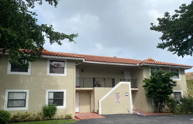 a front view of a house with a plants