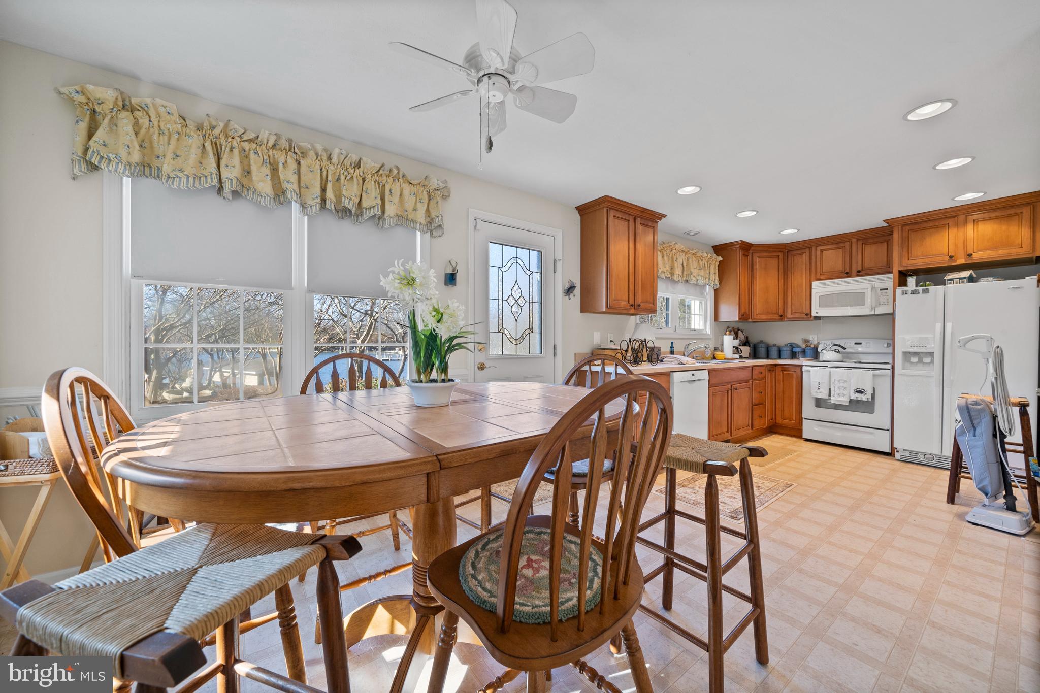 24991 Briscoe Road Hollywood, MD 20636 - Photo 122 of 130 a kitchen with stainless steel appliances kitchen island granite countertop a dining table chairs and a refrigerator