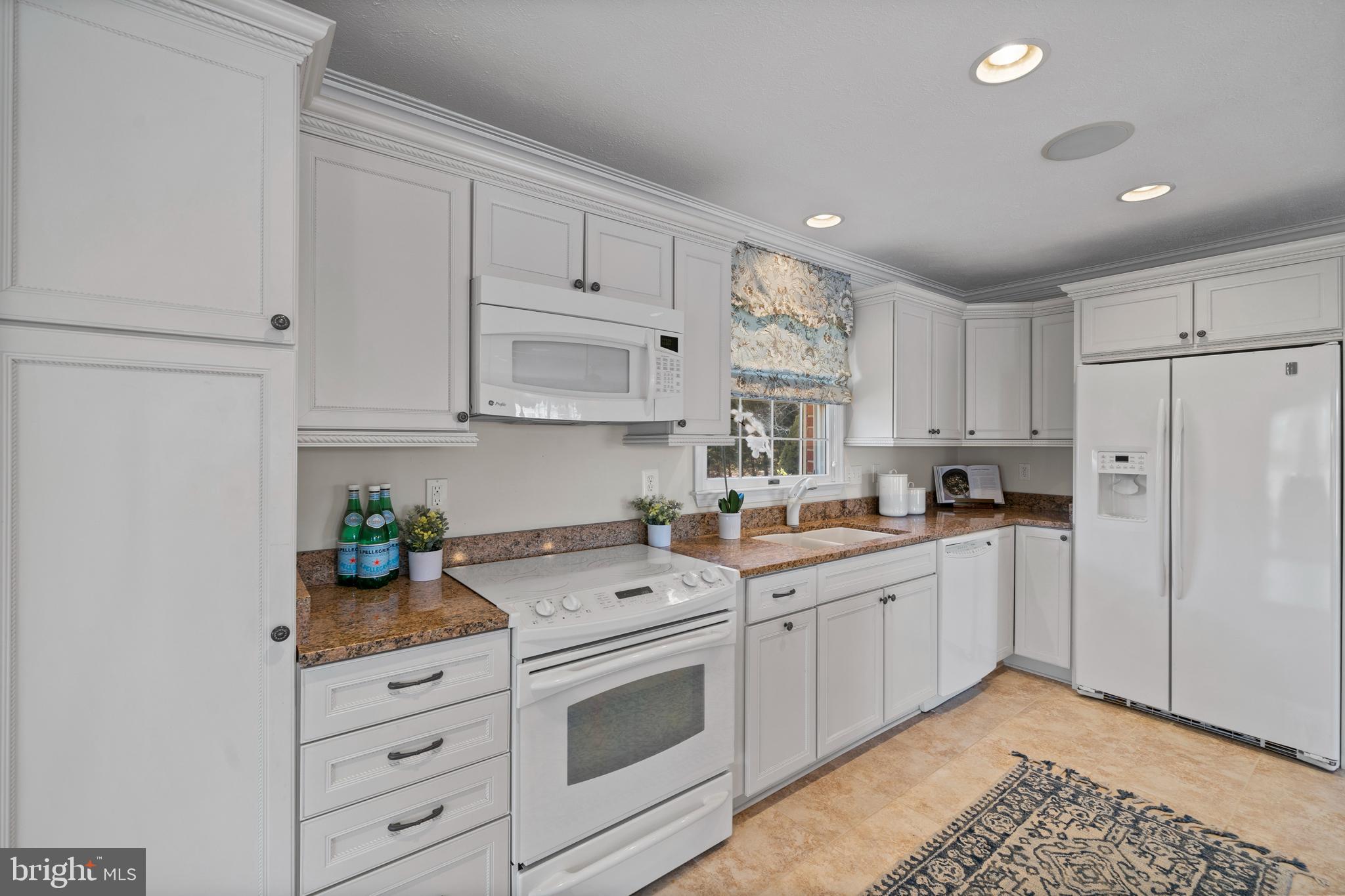 24991 Briscoe Road Hollywood, MD 20636 - Photo 81 of 130 a kitchen with granite countertop a white stove top oven and white cabinets