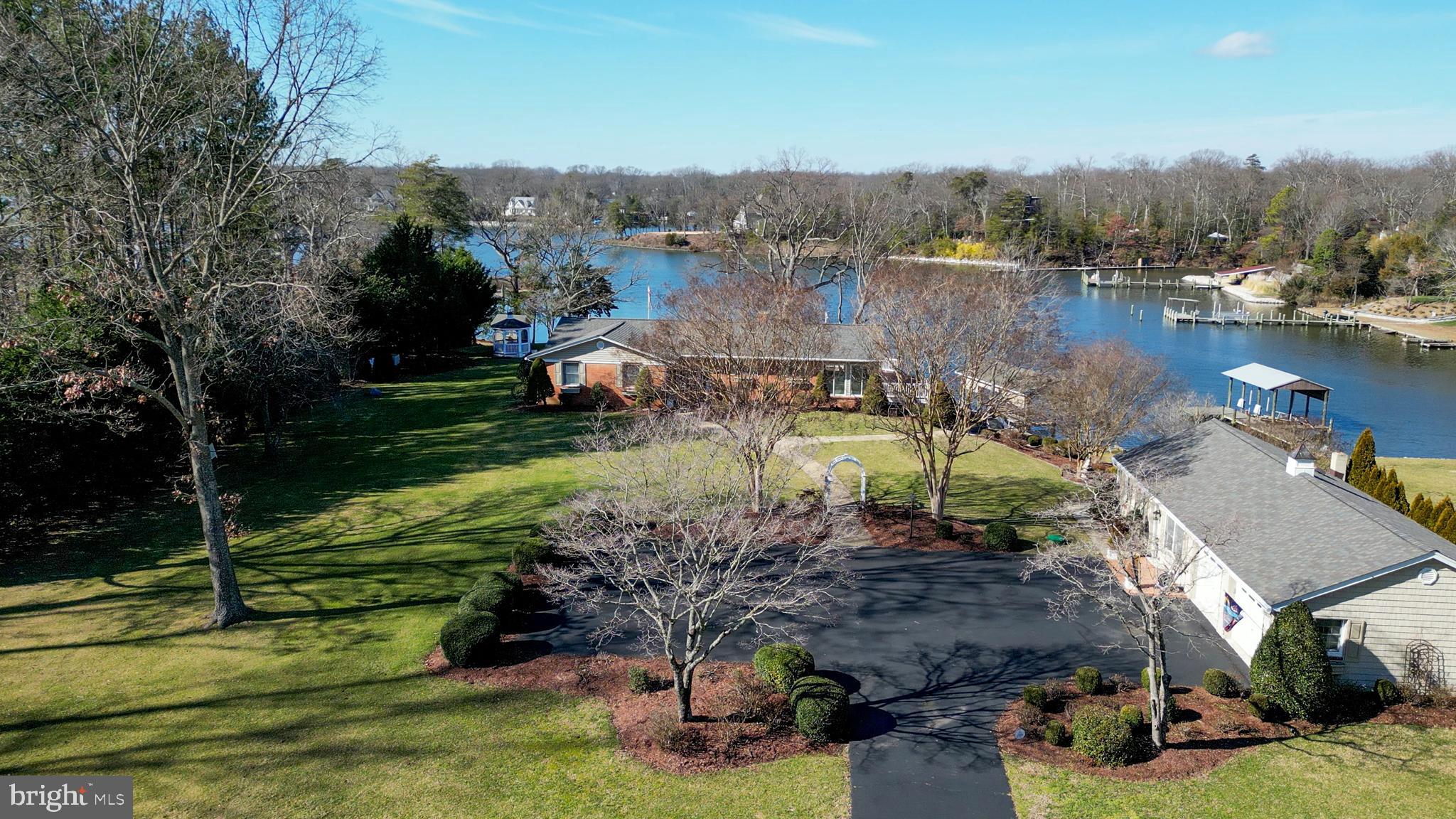 24991 Briscoe Road Hollywood, MD 20636 - Photo 9 of 130 an aerial view of a house with a garden and lake view