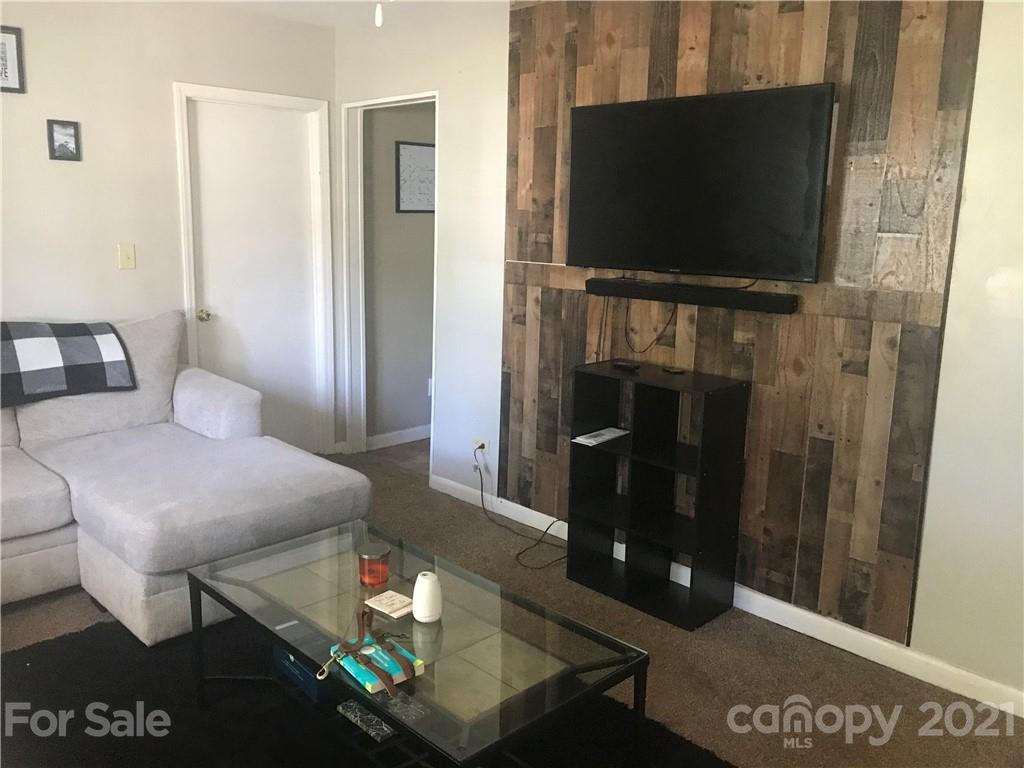 1219 Skyview Road Charlotte, NC 28208 - Photo 2 of 3 a living room with furniture and a flat screen tv