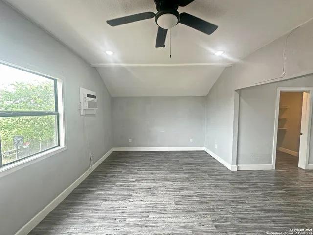 a large kitchen with kitchen island a stove a sink dishwasher a refrigerator and wooden floor