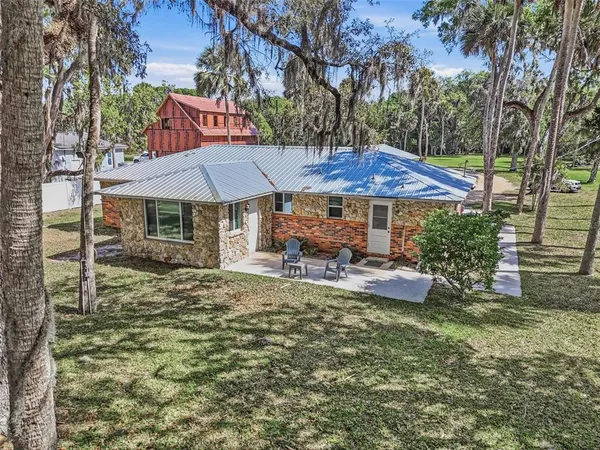 a view of a house with backyard porch and sitting area
