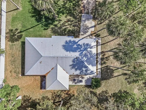 an aerial view of a house with a yard