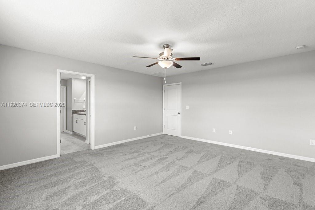 5351 Night Tide Lane Wimauma, FL 33598 - Photo 11 of 22 a view of an empty room with a ceiling fan