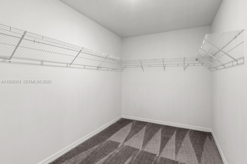 5351 Night Tide Lane Wimauma, FL 33598 - Photo 17 of 22 a view of a room with racks on the wall