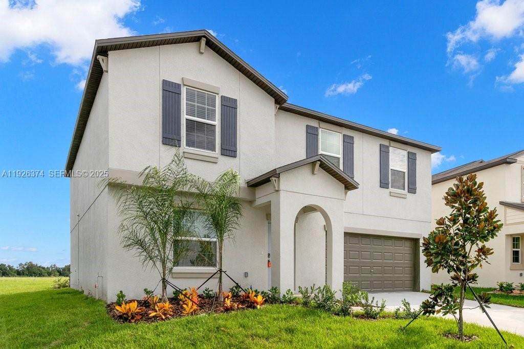 5351 Night Tide Lane Wimauma, FL 33598 - Photo 2 of 22 a front view of house with yard