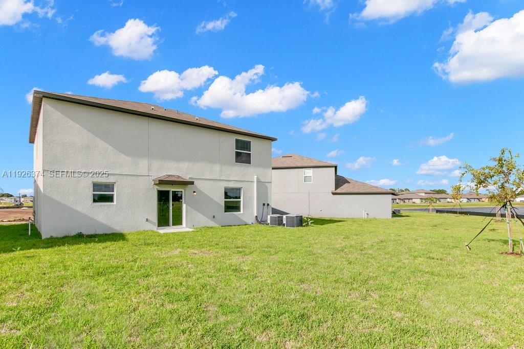 5351 Night Tide Lane Wimauma, FL 33598 - Photo 22 of 22 a view of a house with a yard
