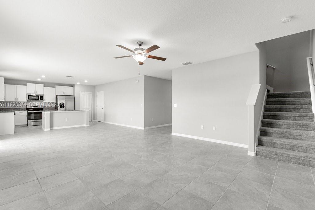 5351 Night Tide Lane Wimauma, FL 33598 - Photo 5 of 22 a view of a kitchen with wooden cabinet and a kitchen space with a sink