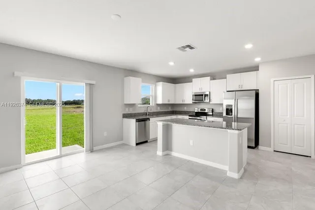 a kitchen with a refrigerator and a sink