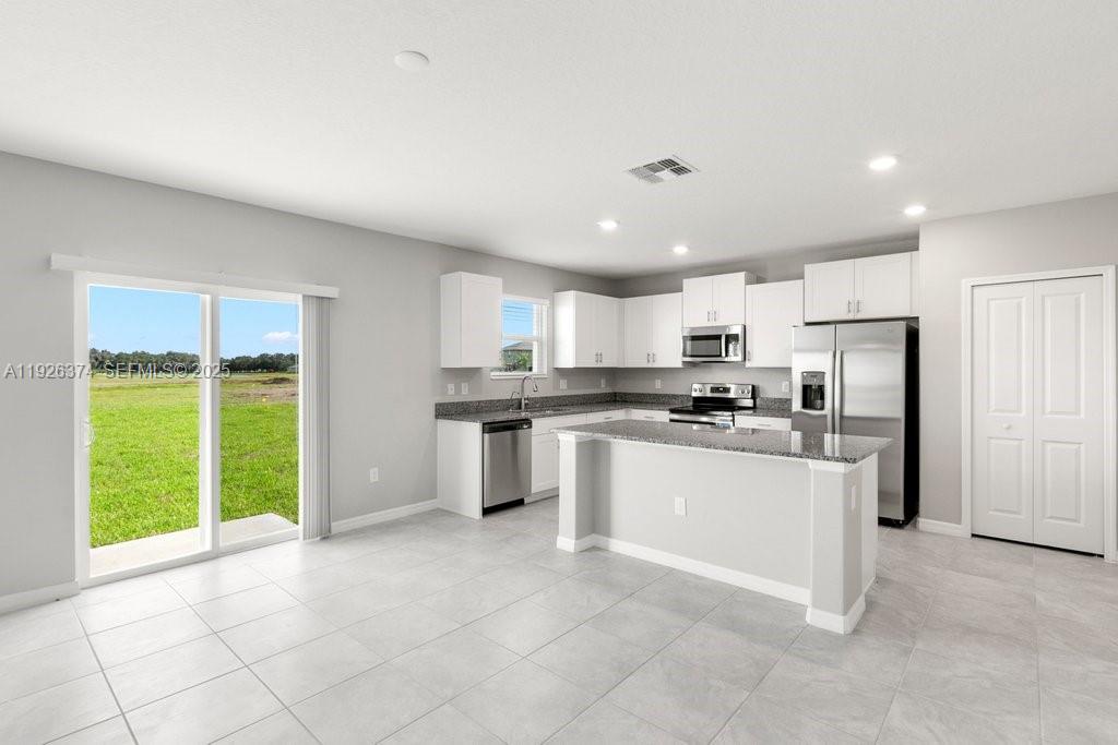 5351 Night Tide Lane Wimauma, FL 33598 - Photo 9 of 22 a kitchen with a refrigerator and a sink