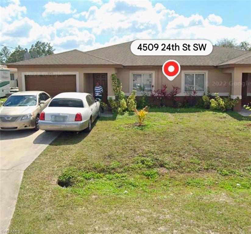 4509 24th Street Southwest Lehigh Acres, FL 33973 - Photo 1 of 1 a view of a back yard of the house