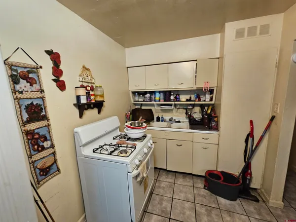 a kitchen with stainless steel appliances a refrigerator and a stove top oven