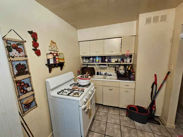 a kitchen with stainless steel appliances a refrigerator and a stove top oven