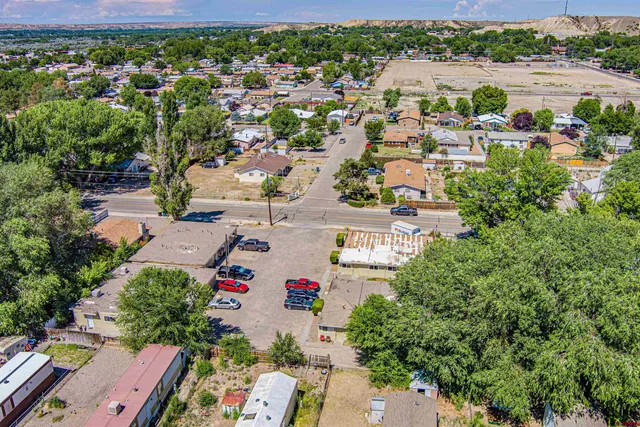 an aerial view of residential houses with outdoor space and river view